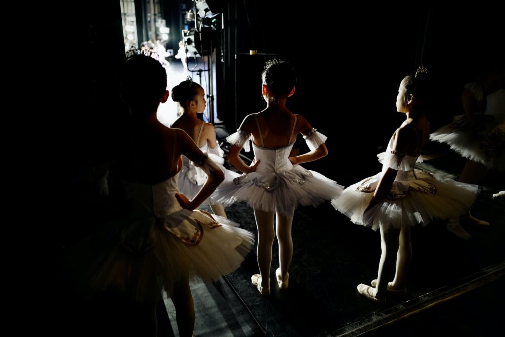 young ballet dancers waiting on the wings of a stage